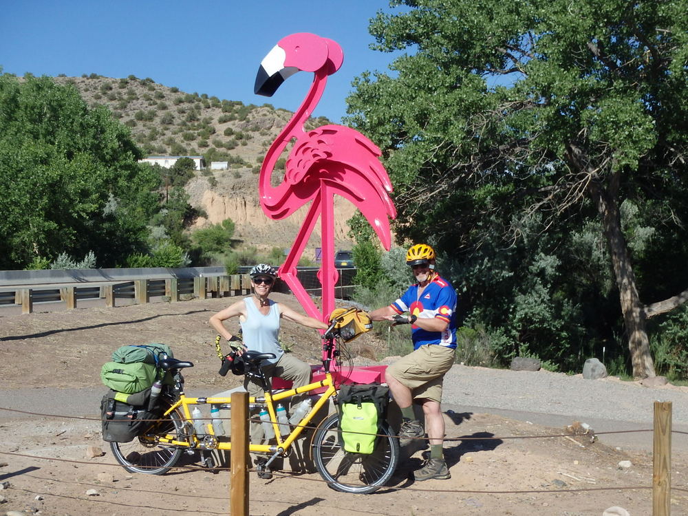 Terry Struck, Dennis Struck, and the Bee pose at the Steele Flamingo in front of Bodes Gas Station and Country Market beside the Rio Chama in Abiquiu, New Mexico, on the GDMBR.